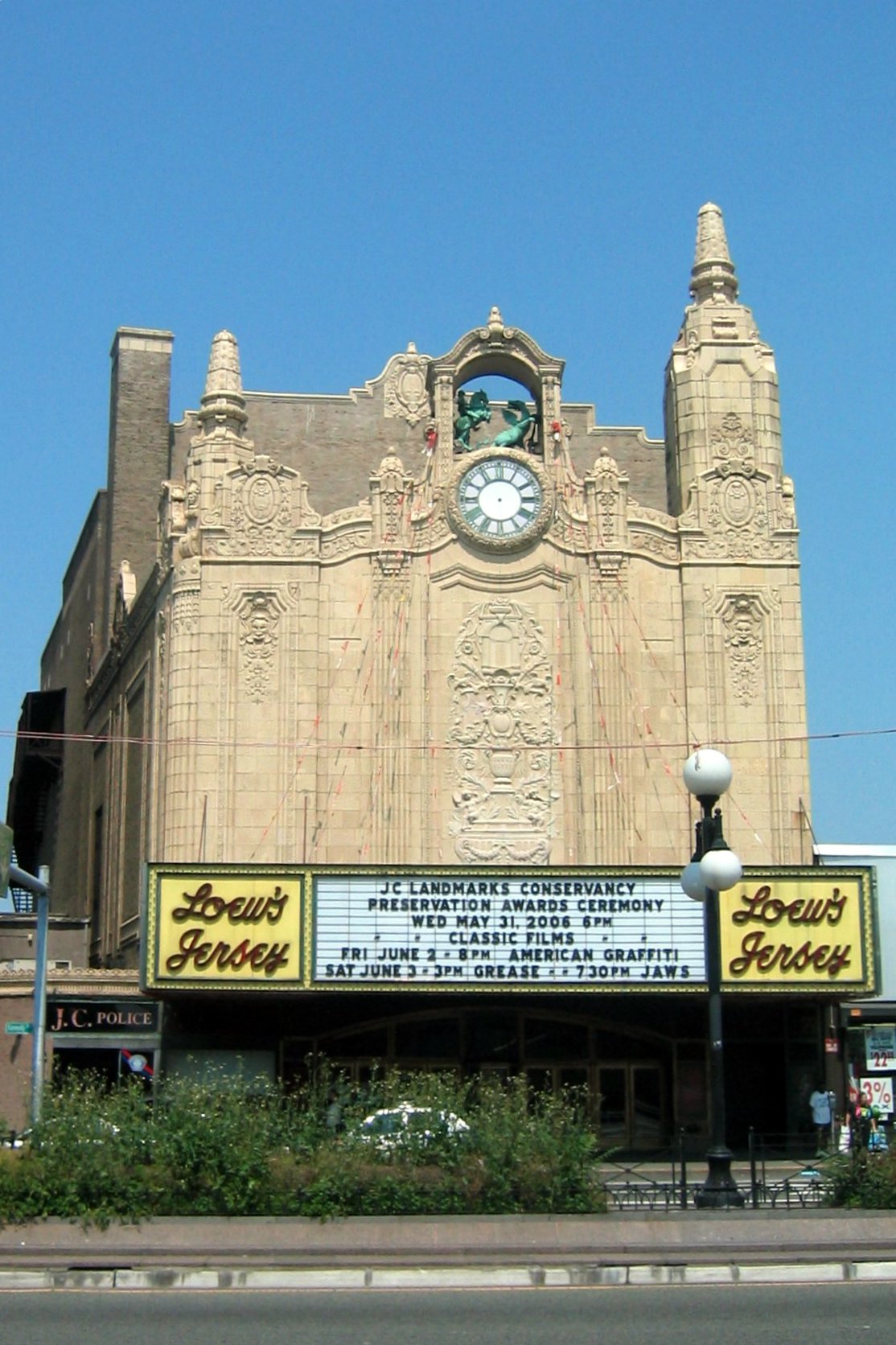Loew's Jersey Theatre exterior with marquee displaying classic film events, located near Uforia Dispensary in Journal Square, Jersey City, NJ.