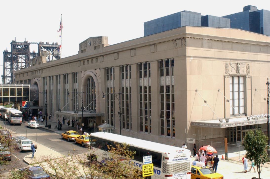 Newark Penn Station exterior view with taxis and buses, serving as a transportation hub near Uforia Dispensary in Jersey City, NJ.