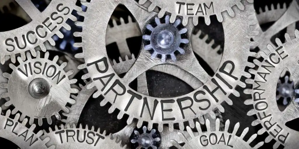 Gears interlocking with words like "Partnership," "Success," "Vision," and "Trust," symbolizing collaboration and community engagement.